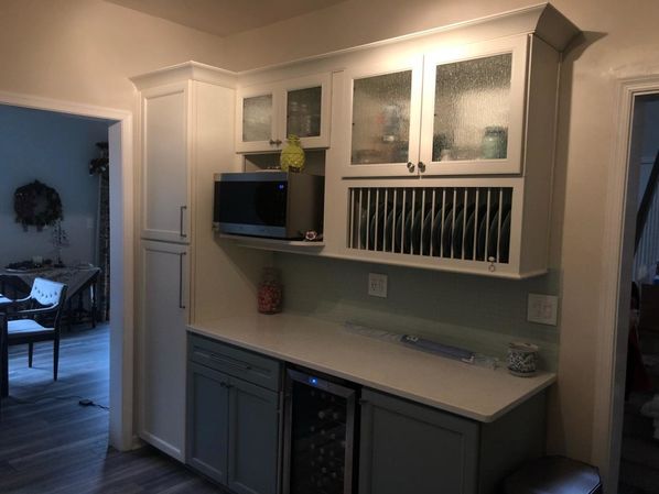 Kitchen Remodeling in Williamsburg, VA. New Cabinets with custom rain glass inserts, new quartz countertops. mosaic tile backsplash, new wiring and lighting, painting and trim and new laminate flooring. (3)