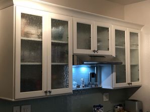 Kitchen Remodeling in Williamsburg, VA. New Cabinets with custom rain glass inserts, new quartz countertops. mosaic tile backsplash, new wiring and lighting, painting and trim and new laminate flooring. (1)