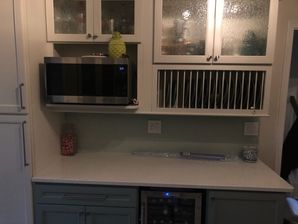Kitchen Remodeling in Williamsburg, VA. New Cabinets with custom rain glass inserts, new quartz countertops. mosaic tile backsplash, new wiring and lighting, painting and trim and new laminate flooring. (2)